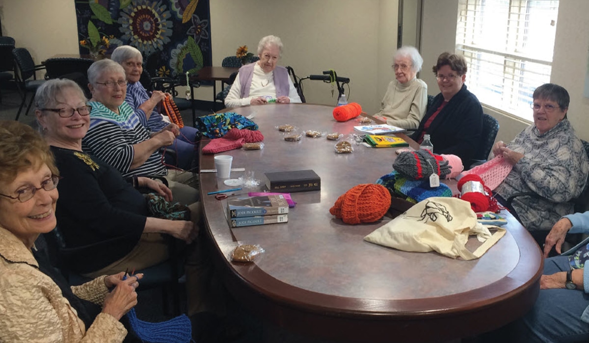a group of people knitting