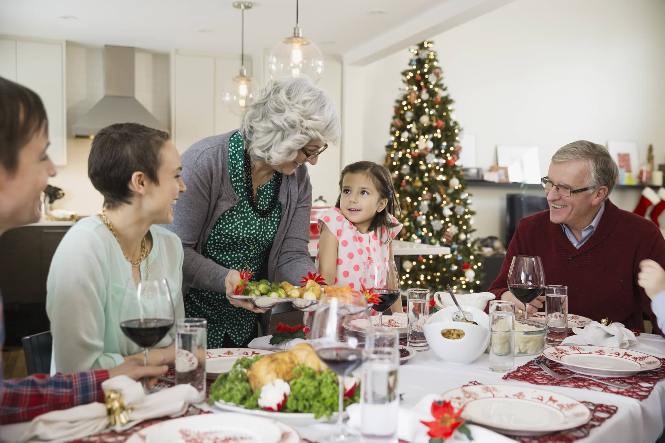 a group of people sitting at a table eating food